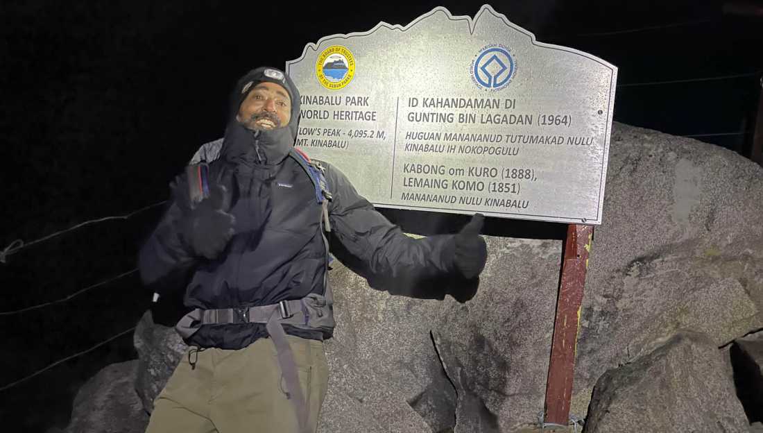 Happy trekker on the summit of Mt Kinabalu |  Brad Atwal