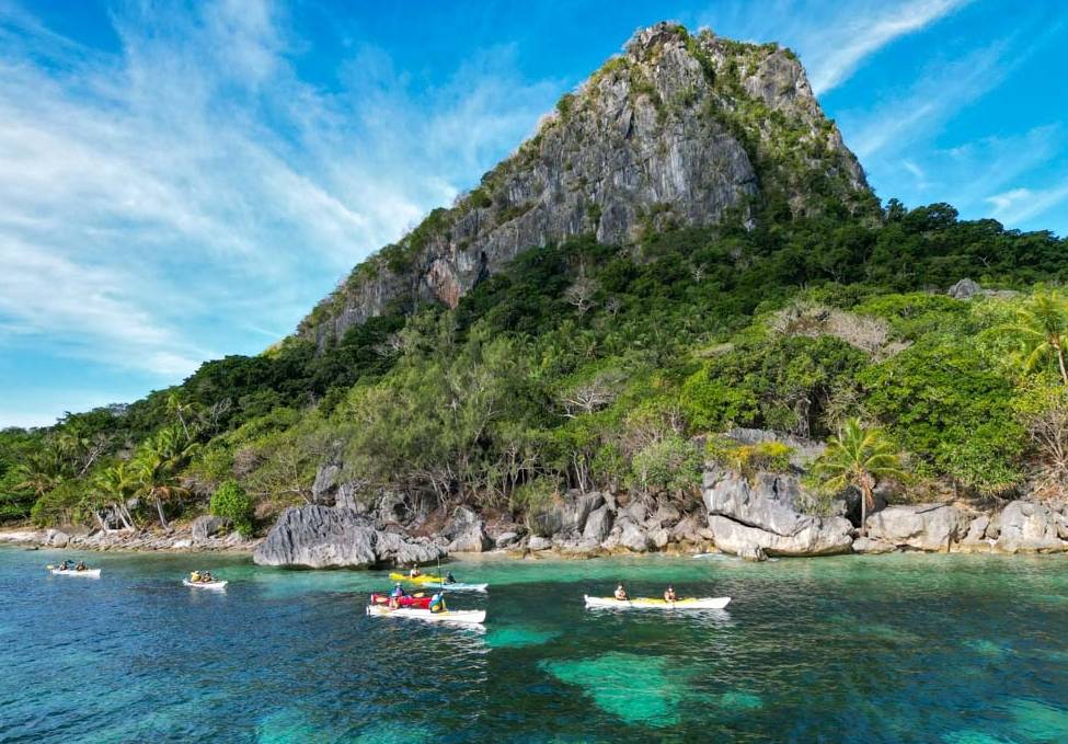Kayaking group paddling the remote tropical waters of the Yasawa Islands
