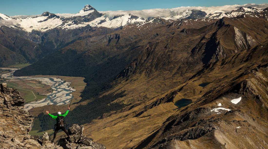 Trekker on Buchanan peak with Mount Aspiring behind, walking above Matukituki valley, near Lake Wanaka | <i>Colin Monteath</i>