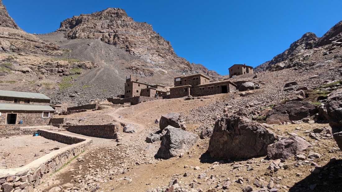 Stone buildings mark the approach to Toubkal’s high camp