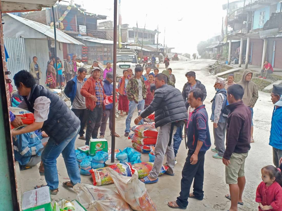 World Expeditions representatives distributing food packages in Rasuwa area