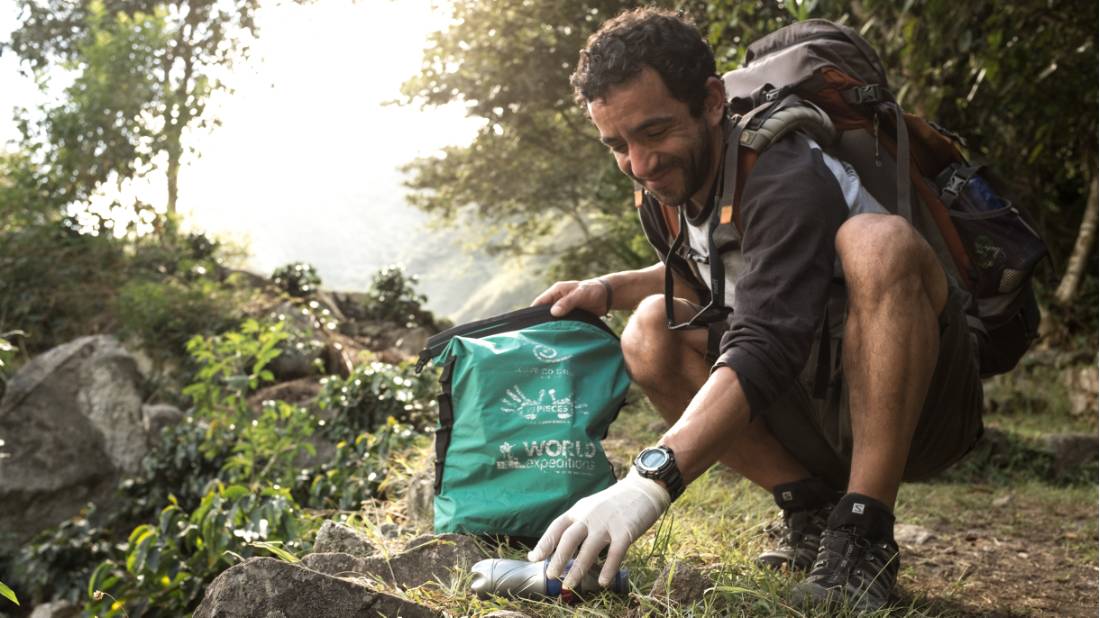 Traveller collecting litter along wilderness trails, part of our 10 Pieces litter collection program |  <i>Mark Tipple</i>